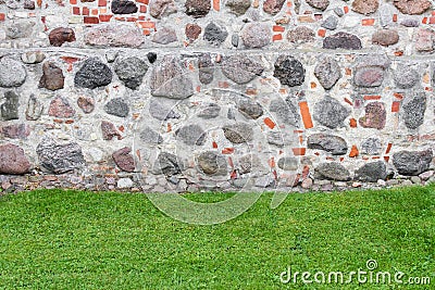 Combination of two textures - stone wall and trimmed grass Stock Photo