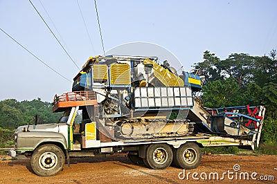 The combine harvested whit on old truck. Stock Photo