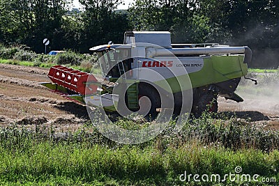 Combine Harvester Harvesting Wheat, Forncett, Norfolk, England, UK Editorial Stock Photo