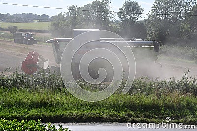 Combine Harvester Harvesting Wheat, Forncett, Norfolk, England, UK Editorial Stock Photo