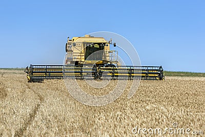 A combine harvester reaping a wheat crop in Australia. Editorial Stock Photo