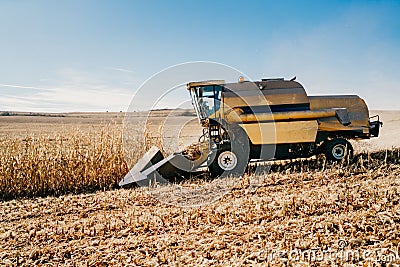 Combine harvester working in the fields. Agriculture Farmer working with machinery Stock Photo