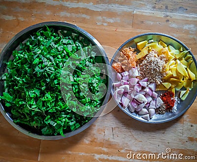 Combined indian spices and ingredients for making spinach curry ( indian cuisine ) with wooden background Stock Photo