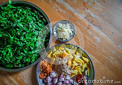 Combined indian spices and ingredients for making spinach curry ( indian cuisine ) with wooden background Stock Photo