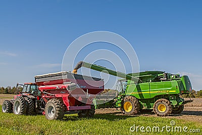 Combined soybean harvest and loading into grain truck Editorial Stock Photo