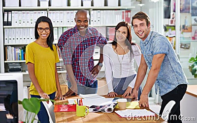 Combining their creative juices. a team of design professionals working together in an office. Stock Photo
