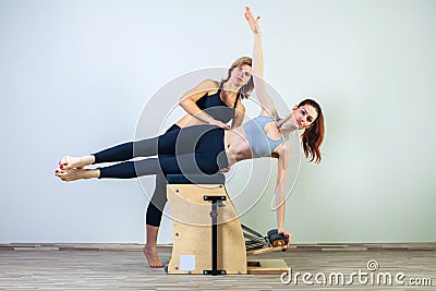 Combo wunda pilates chair woman with instructor Stock Photo