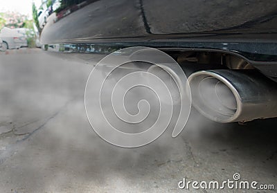 Combustion fumes coming out of black car exhaust pipe, air pollution concept Stock Photo
