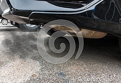 Combustion fumes coming out of black car exhaust pipe, air pollution concep Stock Photo