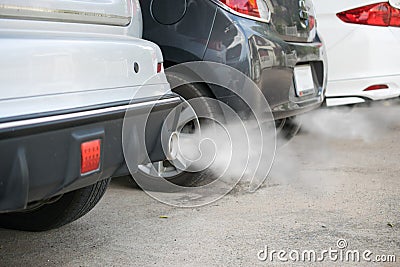 Combustion fumes coming out of car exhaust pipe Stock Photo