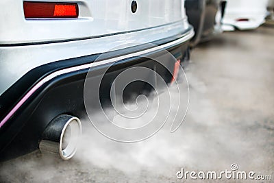 combustion fumes coming out of car exhaust pipe Stock Photo