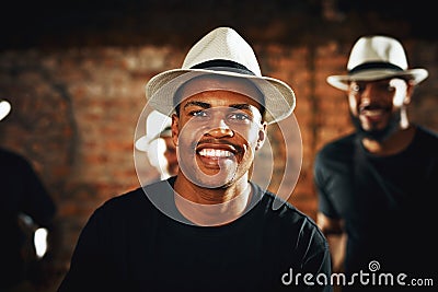 Come party with us. Portrait of a young musical performer playing drums with his band. Stock Photo