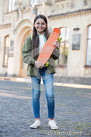 Come to skate and have fun. Happy kid hold penny board. Little skater urban outdoors. Board for transportation Stock Photo