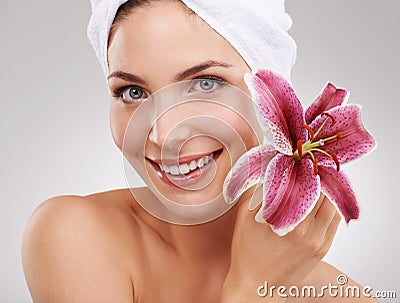 When it comes to beauty nature knows best. Cropped studio shot of a beautiful woman holding a flower against her face. Stock Photo