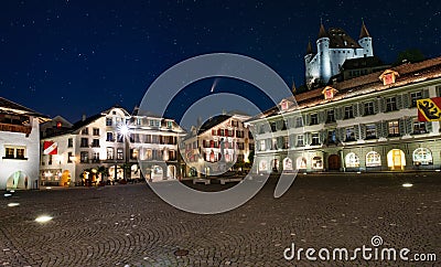 Comet C/2020 F3 Neowise in night sky over Town square with illuminated buildings and castle of Thun, Switzerland Editorial Stock Photo