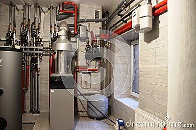 comfort House. boiler, water heater, expansion tank and other pipes. modern independent heating system in boiler room Stock Photo