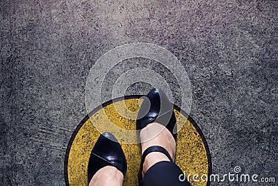 Comfort zone concept, woman with leather shoes steps over circle Stock Photo