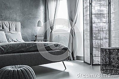 Comfortable bedroom with gray wall Stock Photo