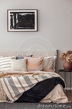 Cozy pillows on comfortable big king size bed in bright bedroom interior in elegant apartment Stock Photo