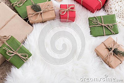 Comfortable Christmas background. Colorful craft gift boxes on fur Stock Photo