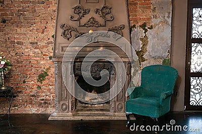 Comfortable green chair and cozy fireplace. nobody. Stock Photo