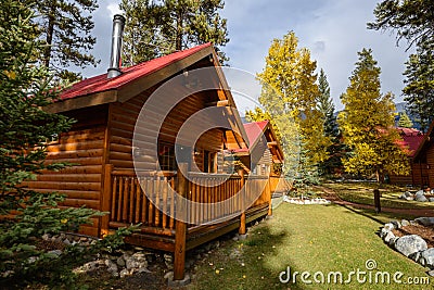 Comfortable quiet wooden hotel at the multicolored fall forest Stock Photo