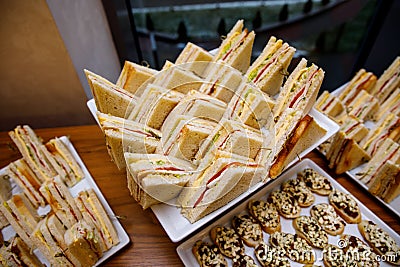 Comfortable triangular sandwiches on the banquet table Stock Photo