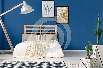 Blue walls and light bedding Stock Photo