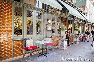 Comfy metal chairs and tables outside a British restaurant Editorial Stock Photo