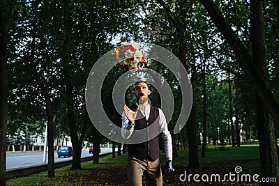 Comic moment of groom catching bridal bouquet with his mouth open Stock Photo