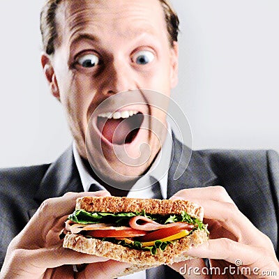 Comical man eating sandwich with funny expression Stock Photo