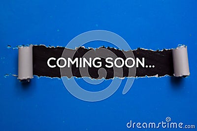 Coming Soon Text written in torn paper Stock Photo