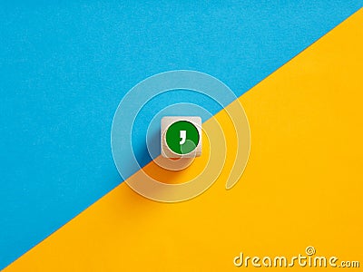 The comma symbol on a wooden cube push button. Separation concept Stock Photo
