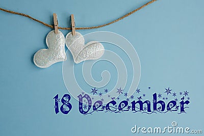 Commemorative date of 18 December on a blue background with white hearts with clothespins, flat lay. Holiday calendar concept. Stock Photo