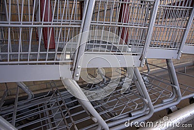Commerce: Three gray grocery carts awaiting use. Stock Photo