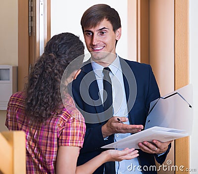 Commercial agent greeting householder and selling subscriptions Stock Photo