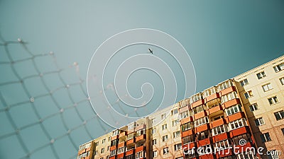 Commercial Airplane Flying Over a Suburbian Part of an Eastern European City on a Sunny Day with Stock Photo