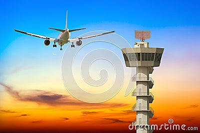 Commercial airplane take off over airport control tower Stock Photo