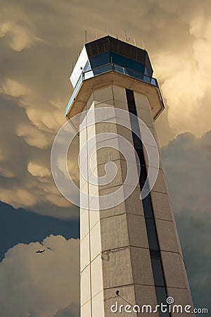 Commercial Airport Control Tower Photo Illustration From Close Up Perspective with large storm developing overhead Stock Photo