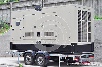 Commercial backup generator. A standby generator is a back-up electrical system that operates automatically. Stock Photo