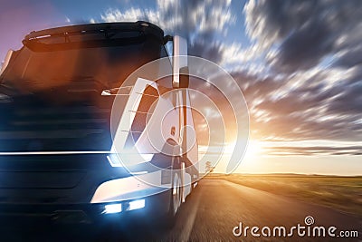 Commercial cargo delivery truck with trailer driving on highway at sunset. Stock Photo