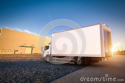 Commercial delivery truck with blank white trailer on cargo parking. Stock Photo