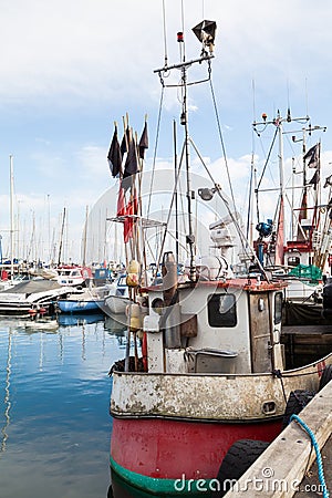 Commercial Fishing Boat in Harbor with Nets and Flags Stock Photo