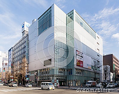 Commercial modern building with cars moving on the road in Sapporo in Hokkaido, Japan Editorial Stock Photo