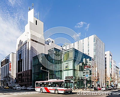 Commercial modern building with moving bus on the road in Sapporo in Hokkaido, Japan Editorial Stock Photo