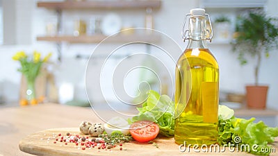 Commercial packshot with olive oil and fresh greens at the table Stock Photo