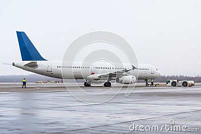 Commercial passenger airplane during push back operation. Stock Photo