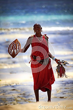 Commercial portrait of young tribal Masai warrior man on hot bright sunny African beach Editorial Stock Photo