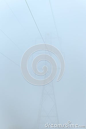 Commercial power lines and self-supporting tower on a very foggy day Stock Photo