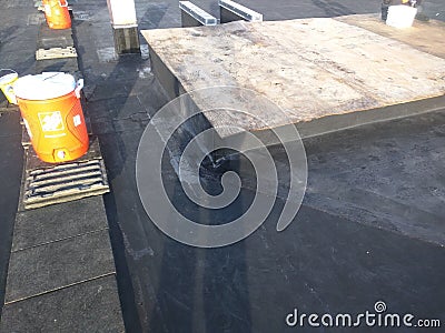 Commercial roofing repairs in progress on EPDM roof; AC curb wrapping Editorial Stock Photo